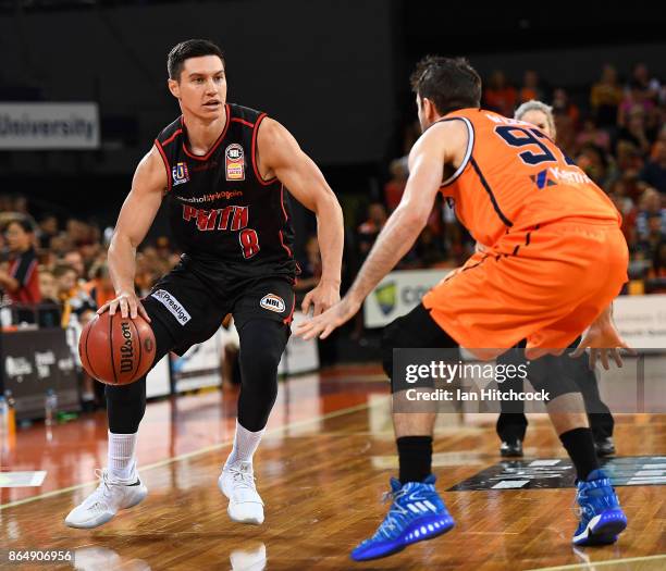 Jarrod Kenny of the Wildcats looks to get past Jarrad Weeks of the Taipans during the round three NBL match between the Cairns Taipans and the Perth...