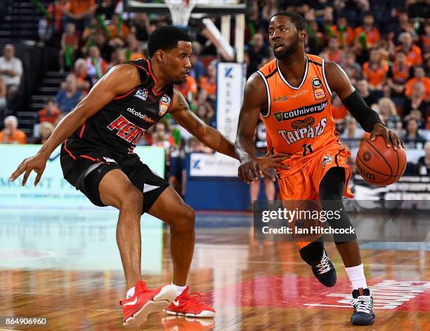 Scoochie Smith of the Taipans looks to get past Bryce Cotton of the Wildcats during the round three NBL match between the Cairns Taipans and the...