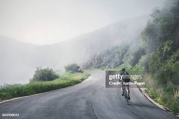 cyclist on the gibraltar road climb - uphill stockfoto's en -beelden