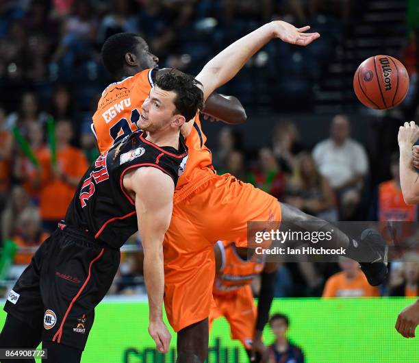 Nnanna Egwu of the Taipans contests the ball with Angus Brandt of the Wildcats during the round three NBL match between the Cairns Taipans and the...