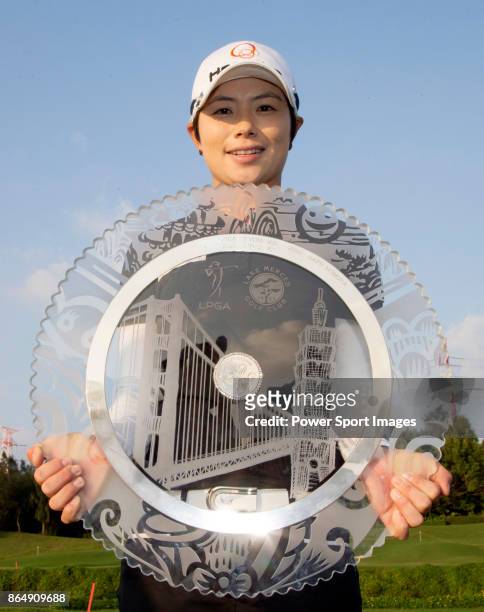 Eun-Hee Ji of South Korea poses while holding the trophy on the 18th green after winning the Swinging Skirts LPGA Taiwan Championship on October 22,...