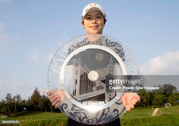 Eun-Hee Ji of South Korea poses while holding the trophy on the 18th green after winning the Swinging Skirts LPGA Taiwan Championship on October 22,...