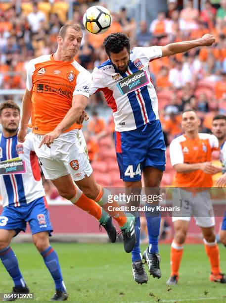 Luke DeVere of the Roar and Nikolai Topor-Stanley of the Jets challenge for the ball during the round three A-League match between the Brisbane...
