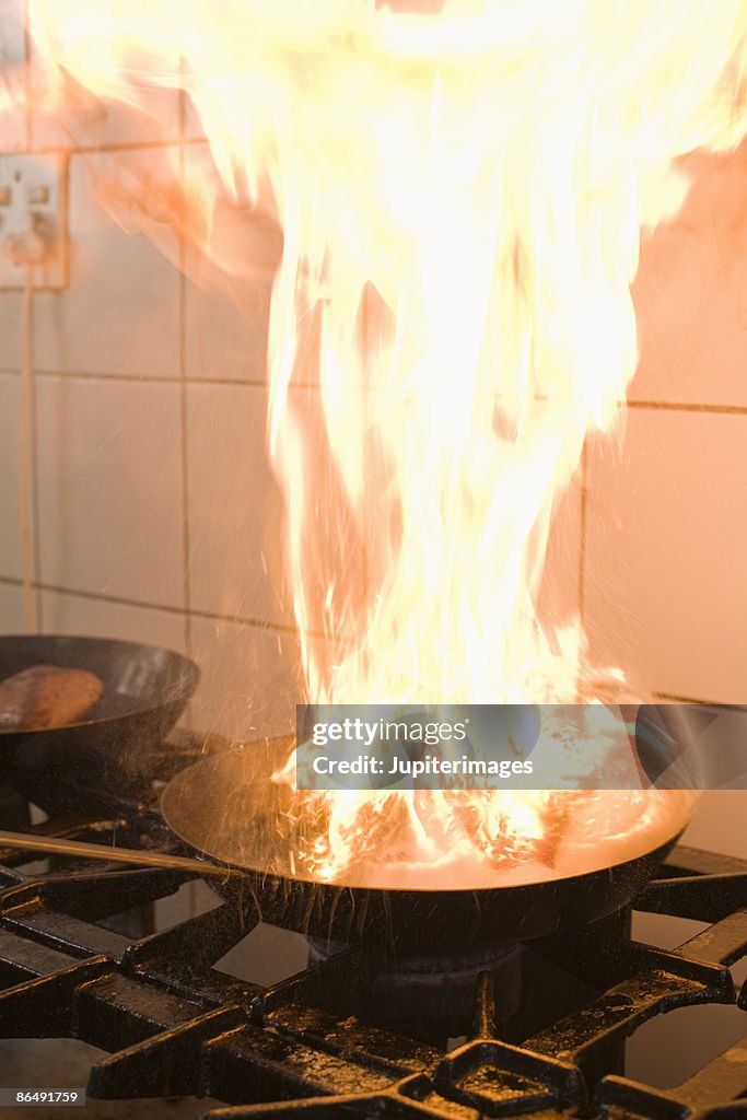 Flaming sauce pan on stove