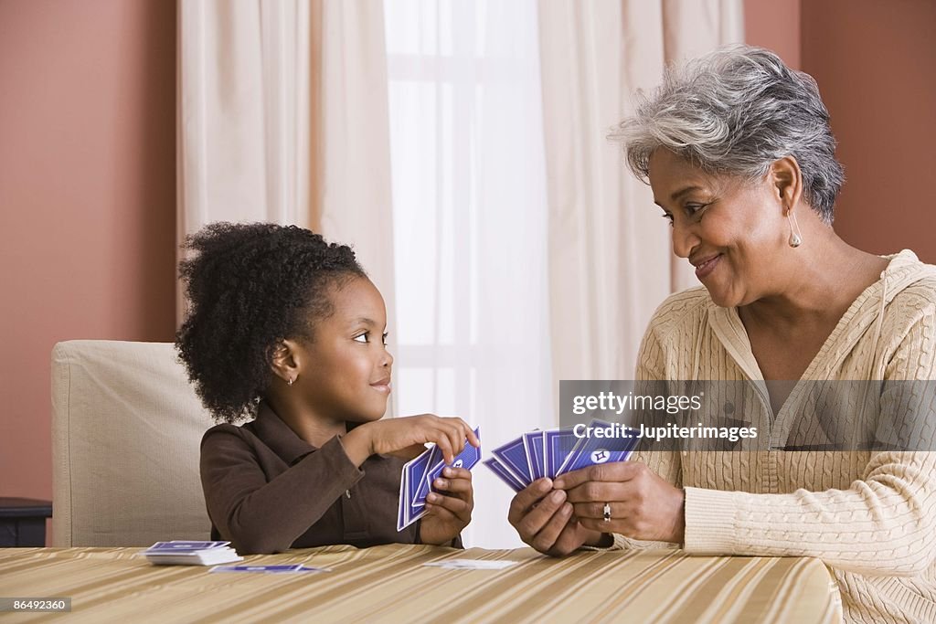 Grandmother and granddaughter playing cards