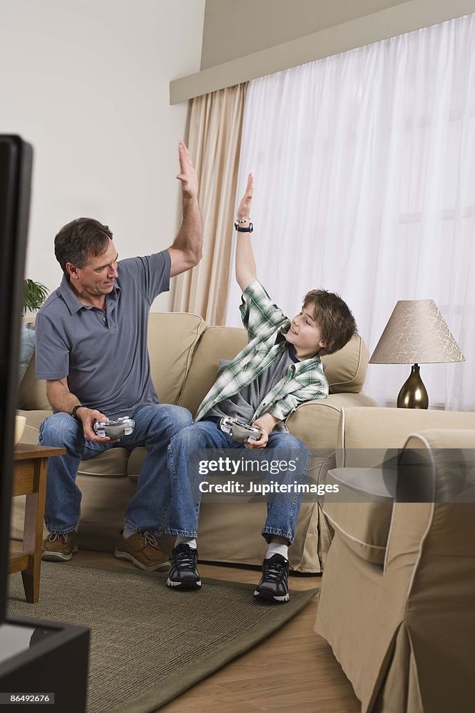 Father and son playing video games