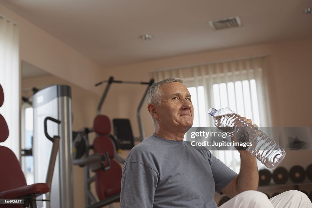 Man drinking water in gym