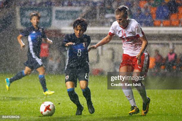 Mana Iwabuchi of Japan and Rahel Kiwic of Switzerland compete for the ball during the international friendly match between Japan and Switzerland at...