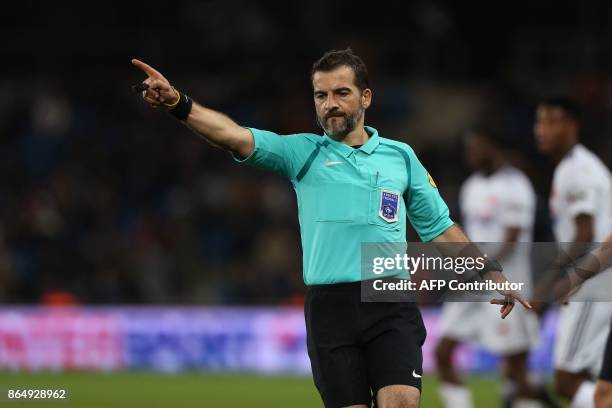 French referee Sebastien Desiage gestures during the French L1 football match between Amiens and Bordeaux on October 21 at the Ocean Stadium, in Le...