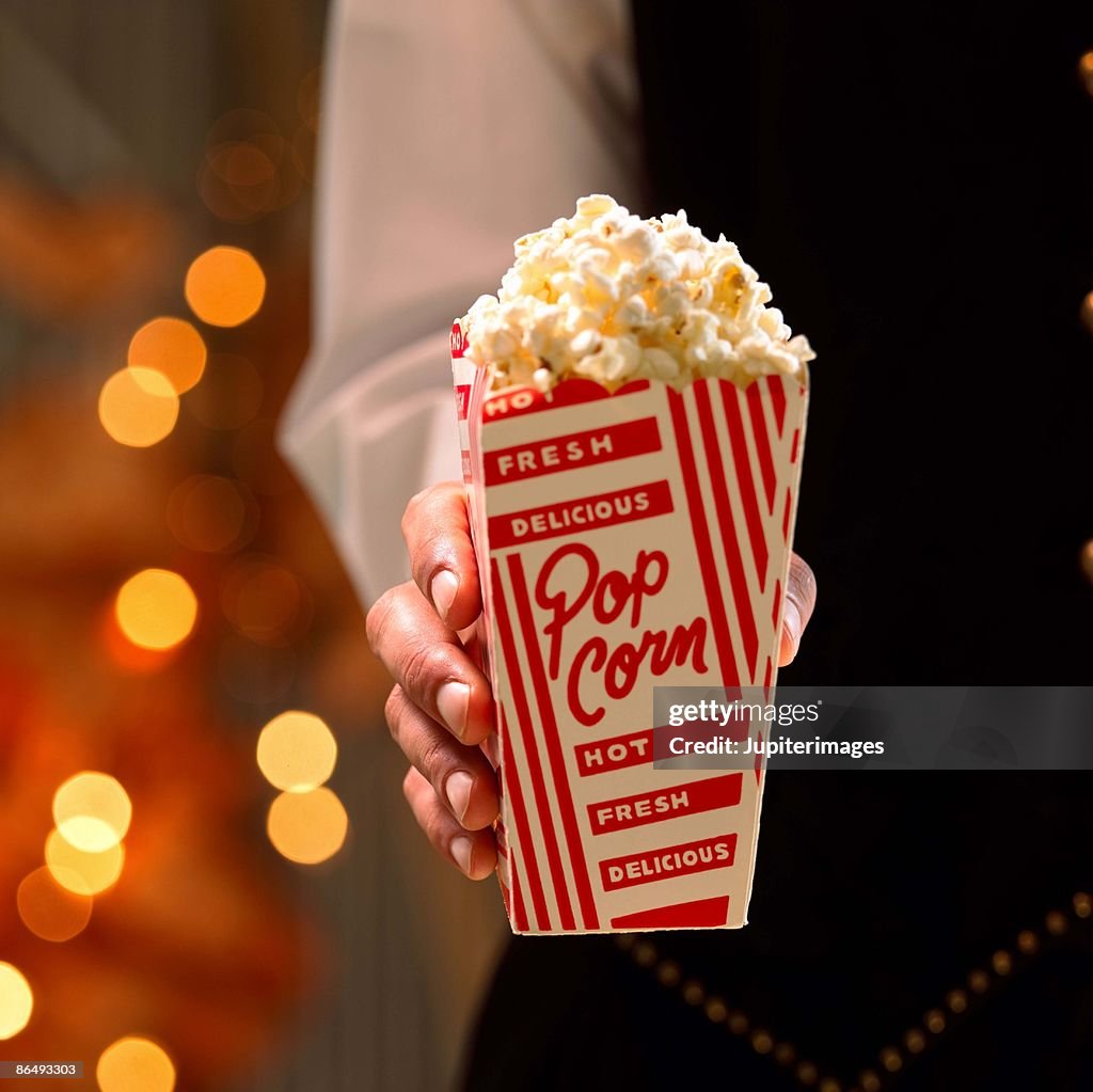 Hand holding popcorn