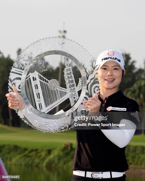 Eun-Hee Ji of South Korea poses for a photo while holding the trophy on the 18th green after winning the Swinging Skirts LPGA Taiwan Championship on...