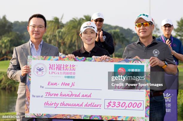 Swinging Skirts Golf Foundation Chairman Johnson Wang , and CTBC Vice-Chairman Morris Li present the winners check to Eun-Hee Ji of South Korea on...