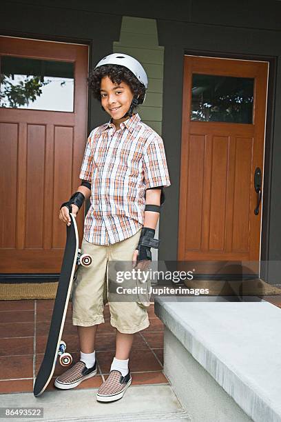 boy with skateboard and helmet - duplex stockfoto's en -beelden