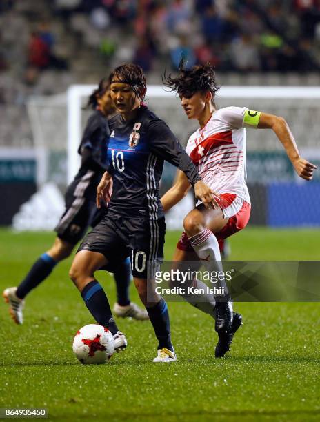 Mizuho Sakaguchi of Japan controls the ball under pressure of Lia Walti of Switzerland during the international friendly match between Japan and...
