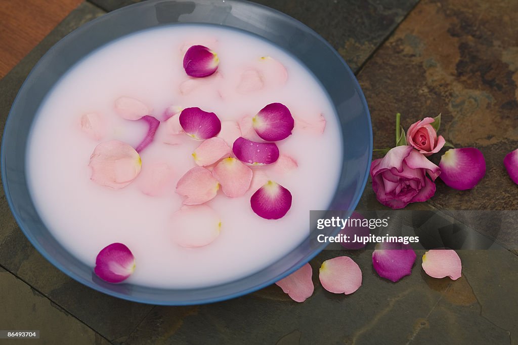 Bowl of milk with rose petals