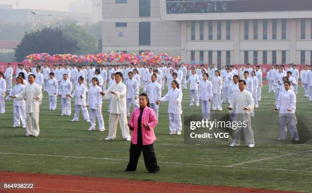 Teachers and students of Xuzhou Medical University perform Tai Chi during the sports meeting on October 21, 2017 in Xuzhou, Jiangsu Province of China.