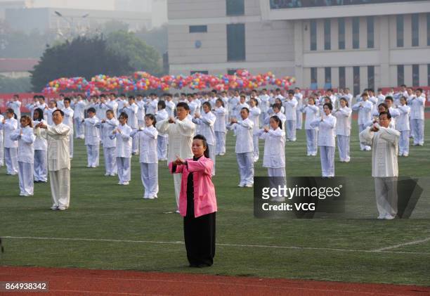 Teachers and students of Xuzhou Medical University perform Tai Chi during the sports meeting on October 21, 2017 in Xuzhou, Jiangsu Province of China.