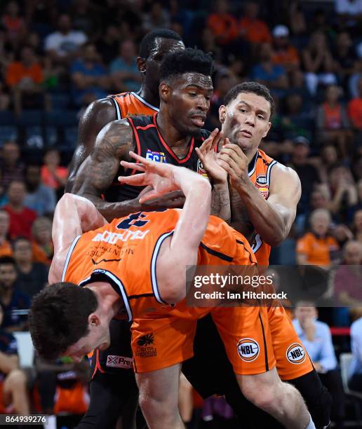 Derek Cooke Jr of the Wildcats contests the ball with Michael Carrera and Cam Gliddon of the Taipans during the round three NBL match between the...