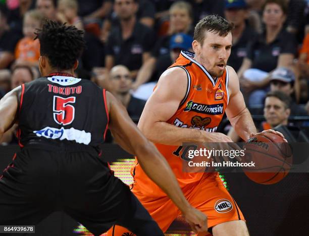 Mitch McCarron of the Taipans drives to the basket past Jean-Pierre Tokoto of the Wildcats during the round three NBL match between the Cairns...