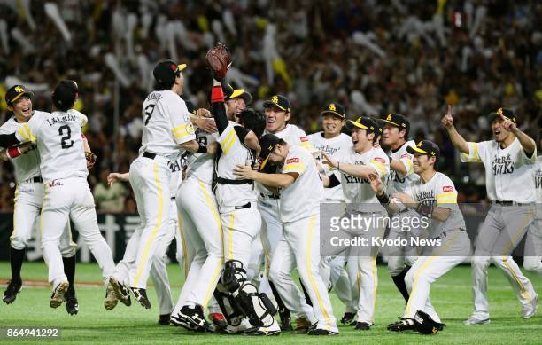SoftBank Hawks players celebrate after a 7-0 victory over the Rakuten Eagles in a Pacific League Climax Series final stage game at Yafuoku Dome in...