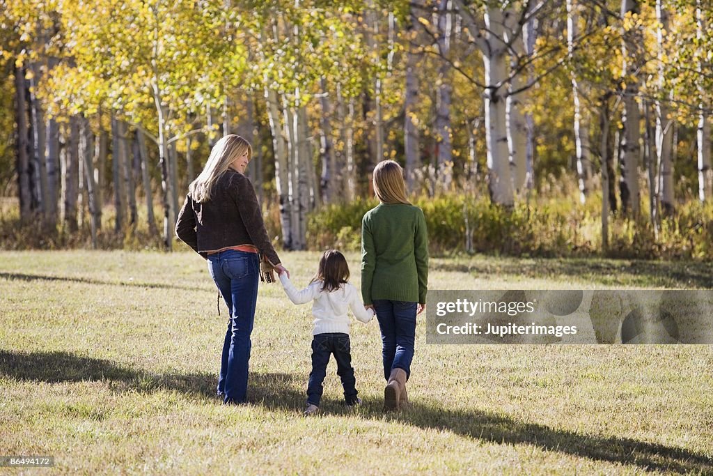 Mother and daughters walking