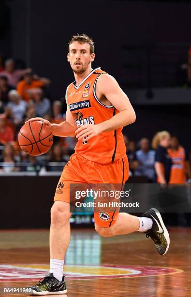 Mitch McCarron of the Taipans dribbles the ball during the round three NBL match between the Cairns Taipans and the Perth Wildcats at Cairns...