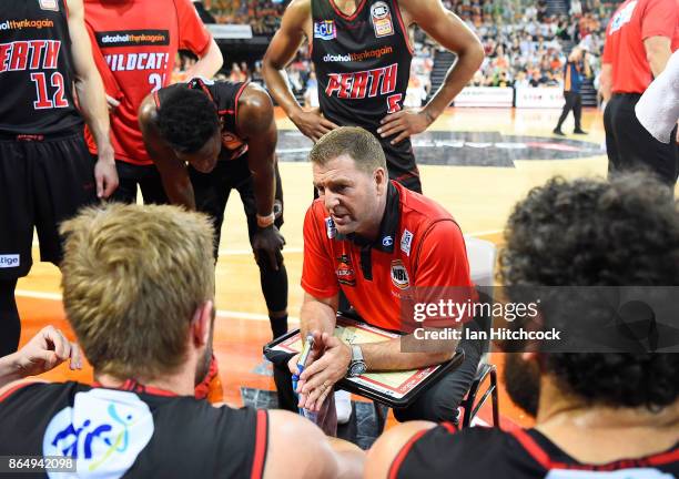 Wildcats coach Trevor Gleeson speaks to his players during a time out during the round three NBL match between the Cairns Taipans and the Perth...