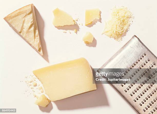 parmesan cheese with grater - reiben stock-fotos und bilder