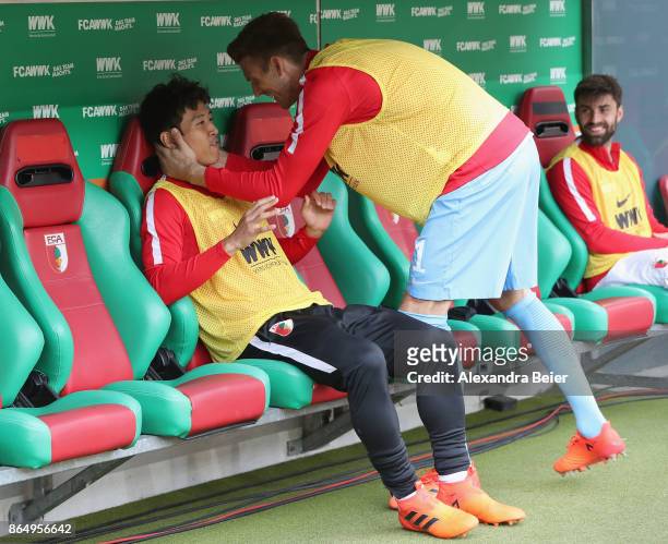 Ja-Cheol Koo and goalkeeper Andreas Luthe of FC Augsburg joke before the Bundesliga match between FC Augsburg and Hannover 96 at WWK-Arena on October...