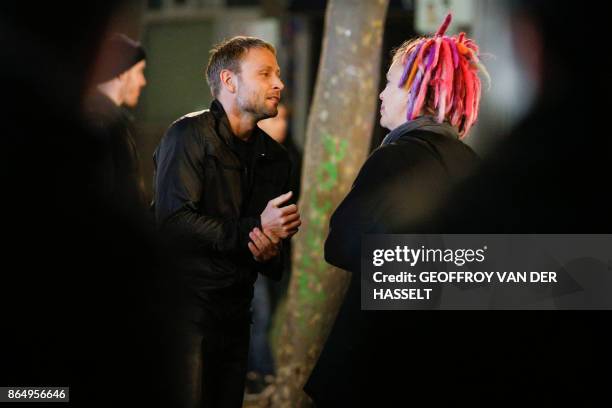 German actor Max Riemelt talks with US director Lana Wachowski on the set of Netflix TV sci-fi series "Sense8" in the Montmartre area of Paris on...