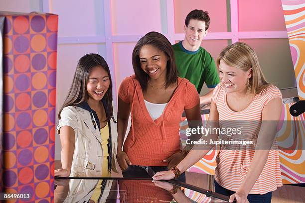 teenagers in an arcade - pinball stock pictures, royalty-free photos & images