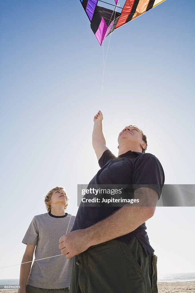 Father and son flying kite