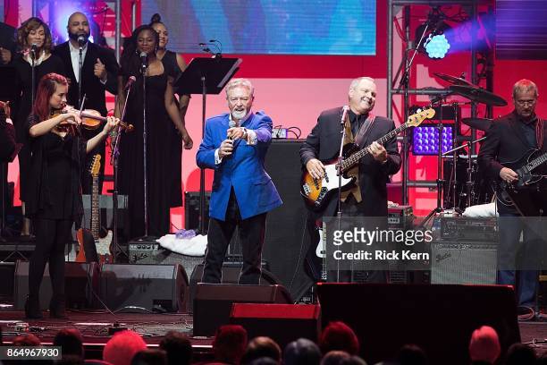 Larry Gatlin and Steve Gatlin of The Gatlins perform onstage during the 'Deep from the Heart: The One America Appeal Concert' at Reed Arena on the...