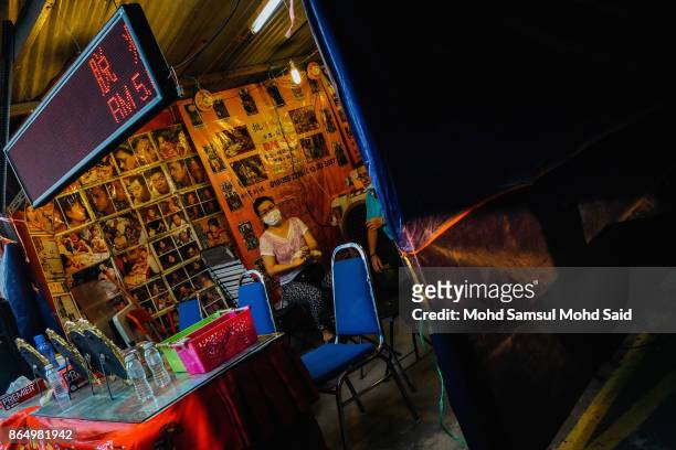 Vendor waits for customers during The Nine Emperor Gods Festival inside the temple on October 22, 2017 in Kuala Lumpur, Malaysia. The Nine Emperor...