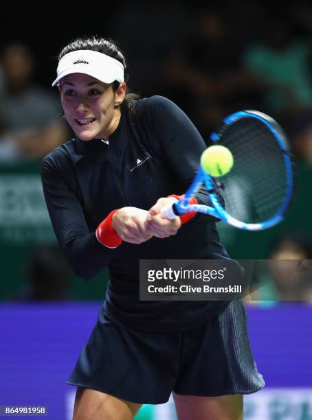 Garbine Muguruza of Spain plays a backhand in her singles match against Jelena Ostapenko of Latvia during day 1 of the BNP Paribas WTA Finals...
