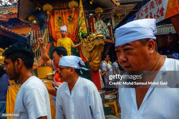 Chinese devotees wait for a feeding of the Soldiers prayer ceremony during The Nine Emperor Gods Festival inside the temple on October 22, 2017 in...