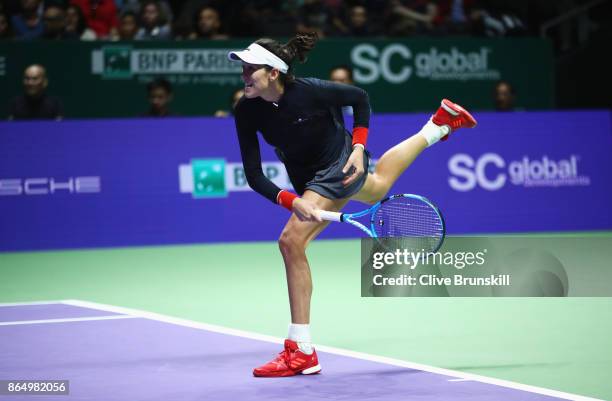 Garbine Muguruza of Spain serves in her singles match against Jelena Ostapenko of Latvia during day 1 of the BNP Paribas WTA Finals Singapore...