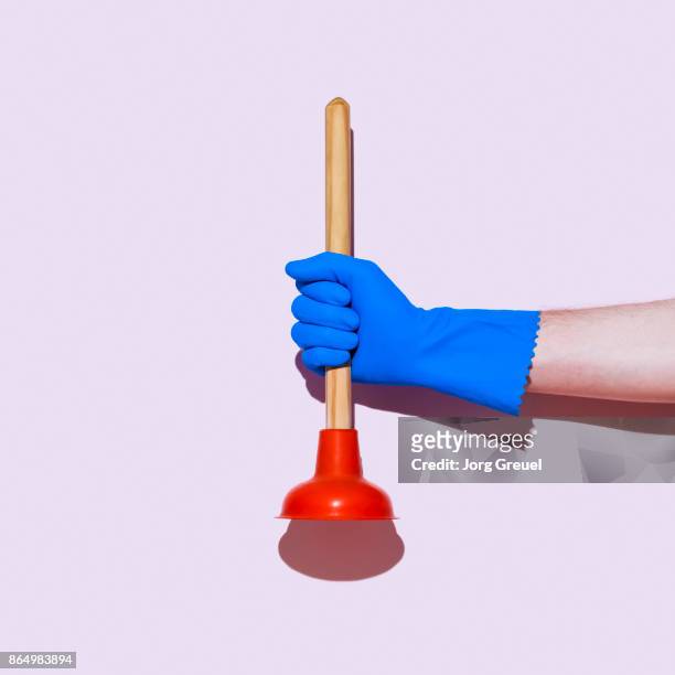 hand in rubber glove holding a plunger - plunger stock pictures, royalty-free photos & images