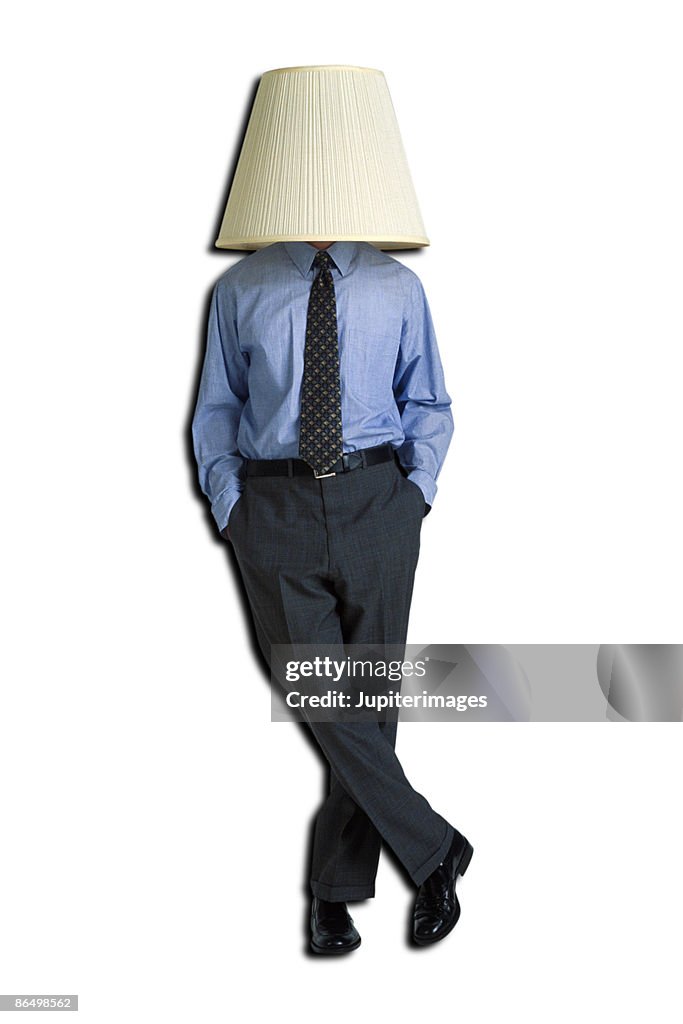 Businessman with lampshade on head