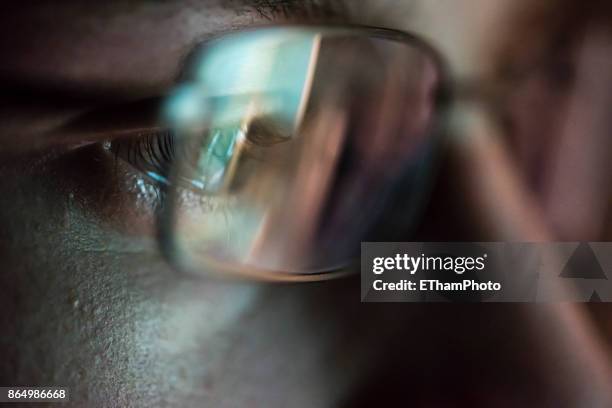 portait of young hacker with computer screen reflecting in the man's glasses. - dark web stock pictures, royalty-free photos & images