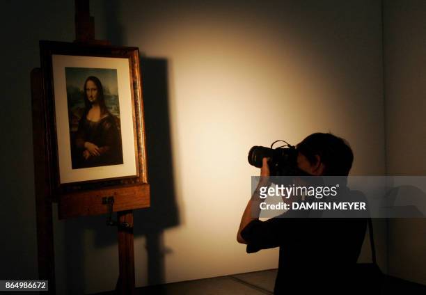 This file photo taken on June 2, 2005 shows a photographer taken a picture of "L.H.O.O.Q", a moustachioed Mona Lisa by dadaist painter Marcel Duchamp...