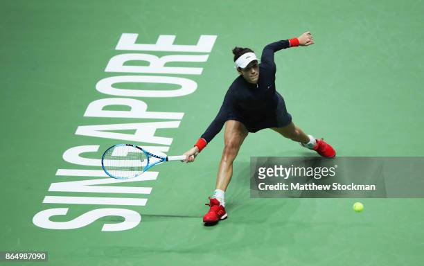 Garbine Muguruza of Spain stretches for a forehand in her singles match against Jelena Ostapenko of Latvia during day 1 of the BNP Paribas WTA Finals...
