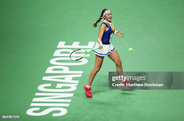 Jelena Ostapenko of Latvia plays a forehand in her singles match against Garbine Muguruza of Spain during day 1 of the BNP Paribas WTA Finals...