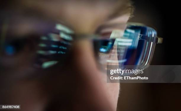 portait of young hacker with computer screen reflecting in the man's glasses. - porträtt man ansikte bakgrundsoskärpa bildbanksfoton och bilder