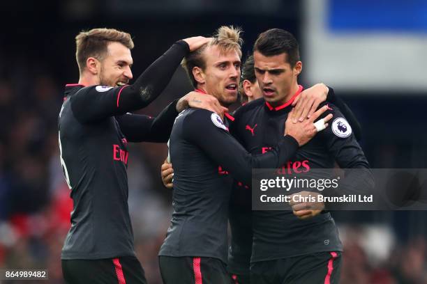 Nacho Monreal of Arsenal is congratulated by team-mates Aaron Ramsey and Granit Xhaka after scoring the equaliser during the Premier League match...