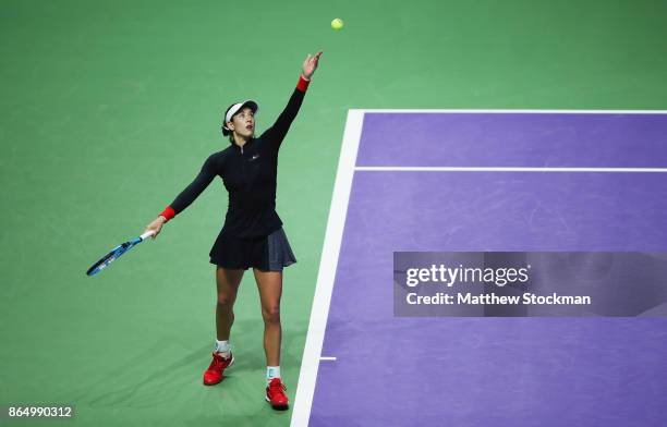 Garbine Muguruza of Spain serves to Jelena Ostapenko of Latvia during day 1 of the BNP Paribas WTA Finals Singapore presented by SC Global at...