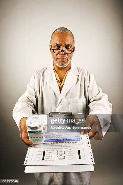 healthcare worker holding drug test - drug testing lab stock pictures, royalty-free photos & images