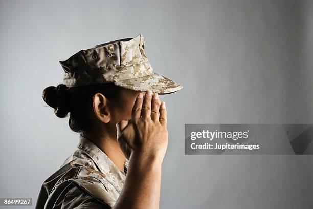 profile of united states marine saluting - female army soldier stock pictures, royalty-free photos & images