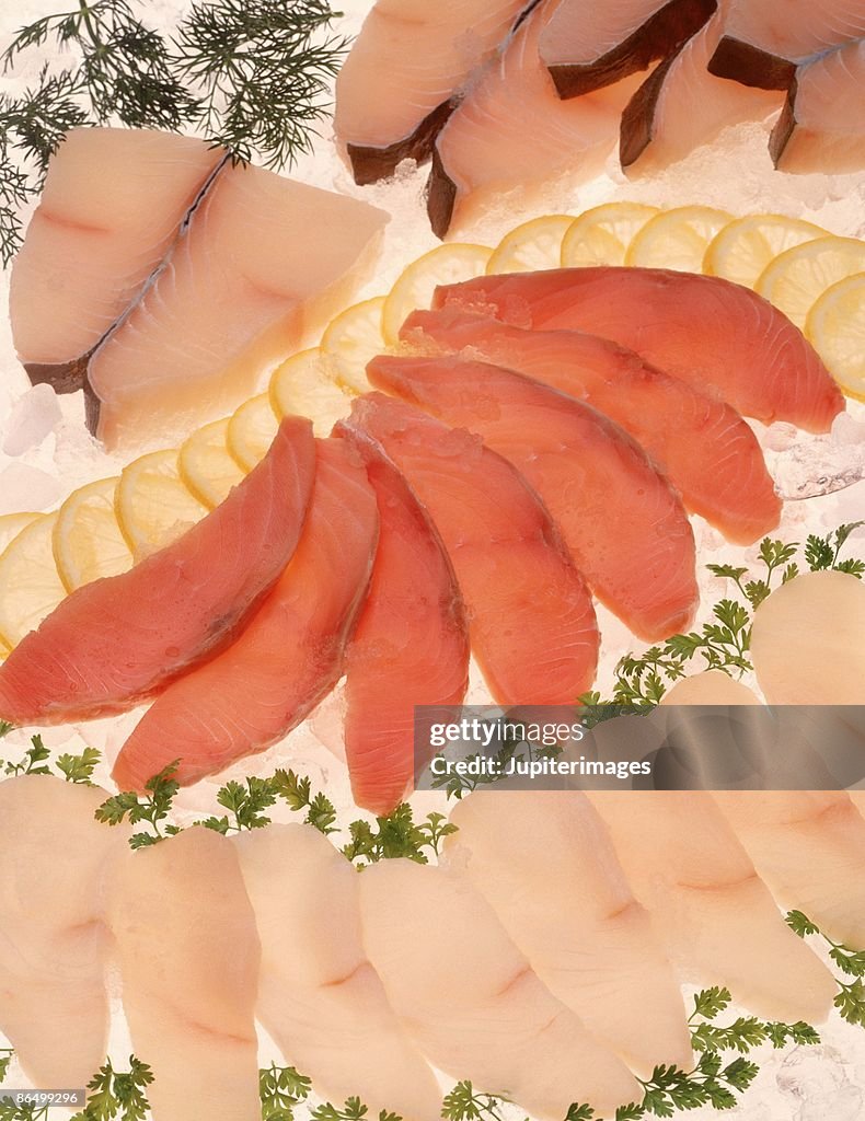 Assorted raw fish fillets on ice