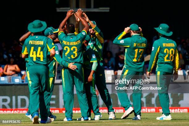 Protea's players celebrate a wicket during the 3rd ODI match at the Buffalo Park, in East London, on October 22, 2017. / AFP PHOTO / MICHAEL SHEEHAN